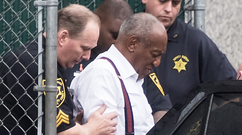 Bill Cosby led out of court house