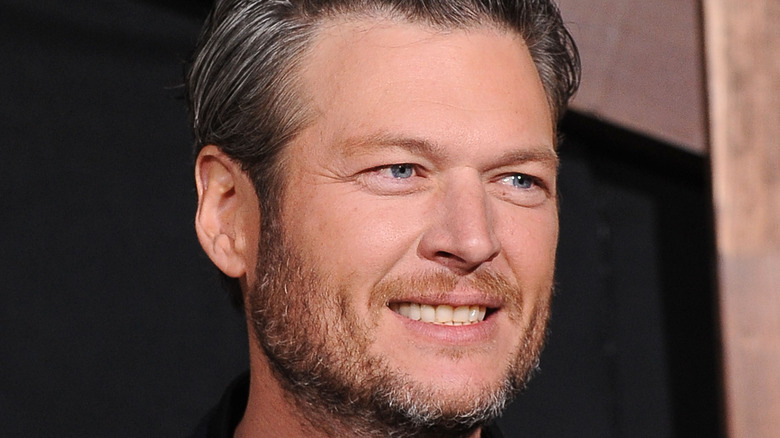 Blake Shelton smiling at a film premiere 