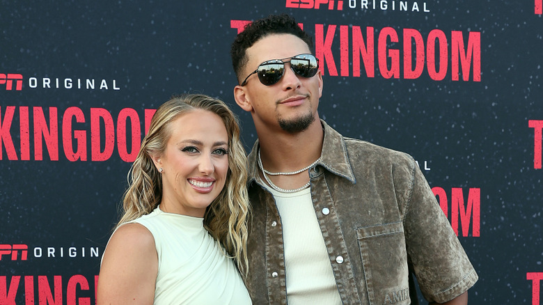 Brittany and Patrick Mahomes smiling while posing for photos together