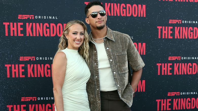 Brittany Mahomes and Patrick Mahomes posing side by side at a red carpet event