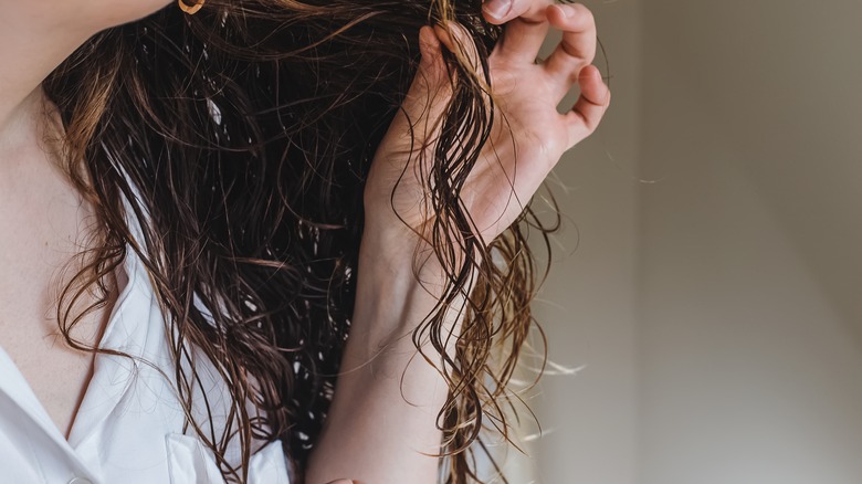 woman holding fine hair strands