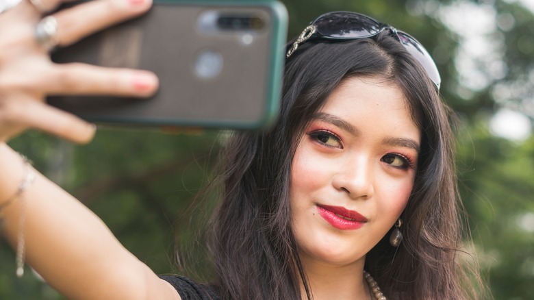 Woman taking a selfie with her phone