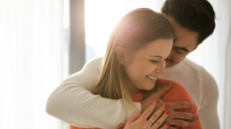 couple hugging smiling