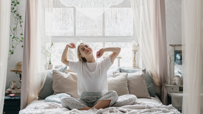 woman stretching in bed