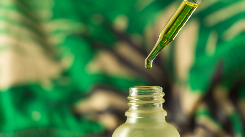 CBD oil dripped into bottle 
