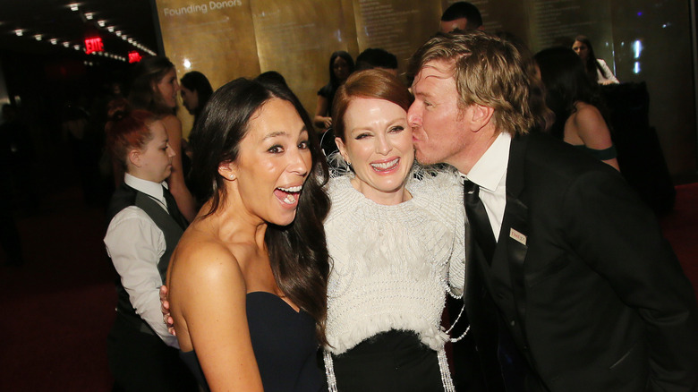 Fixer Upper's Chip Gaines and Joanna Gaines posing with a friend
