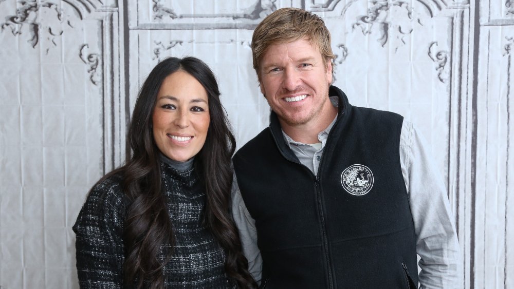 Chip Gaines and Joanna Gaines wearing dark colors
