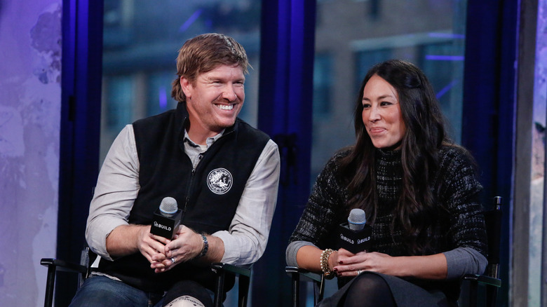 Chip and Joanna Gaines holding microphones