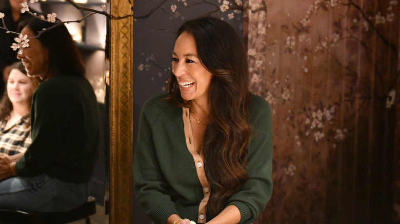 Joanna Gaines seated next to a mirror