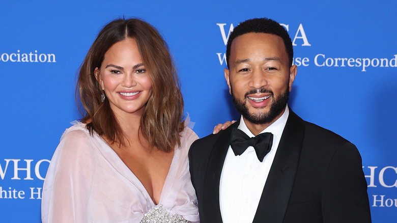 Chrissy Teigen and John Legend posing on the red carpet 