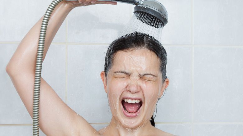 Woman taking cold shower