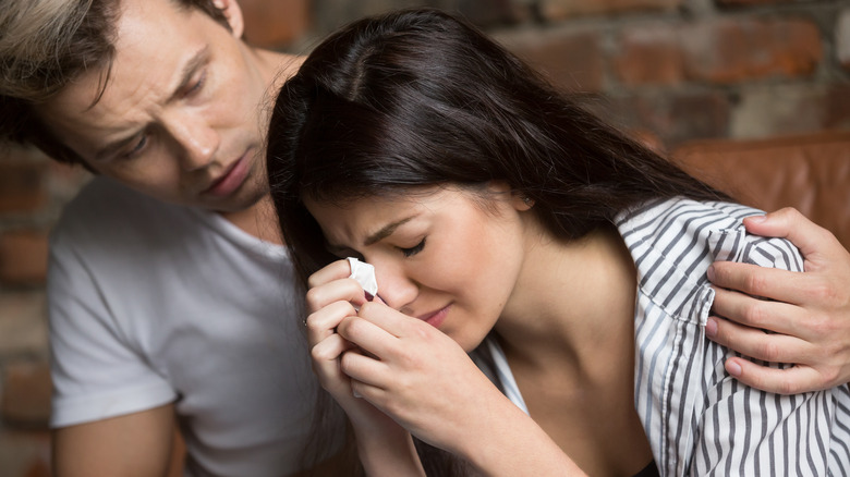 Man comforting sad woman