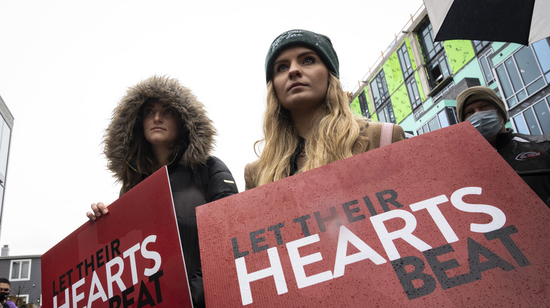 Anti-abortion protestors holding up signs