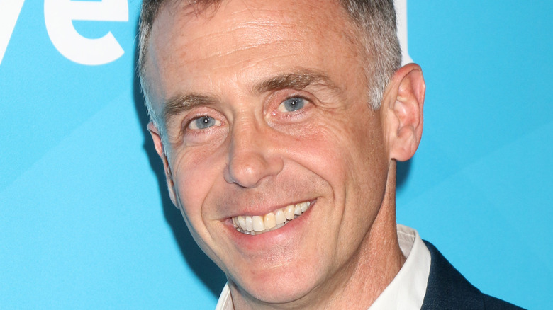 David Eigenberg smiles on the red carpet