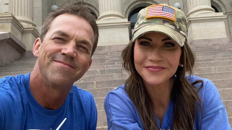 Kristi and Bryon Noem taking a picture on the Supreme Court steps