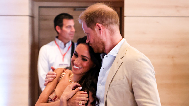 Prince Harry kissing Meghan Markle on the head
