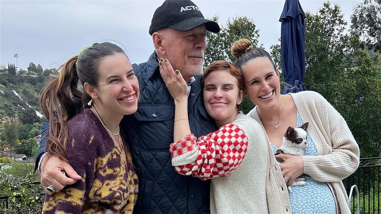 Bruce Willis hugging his three daughters