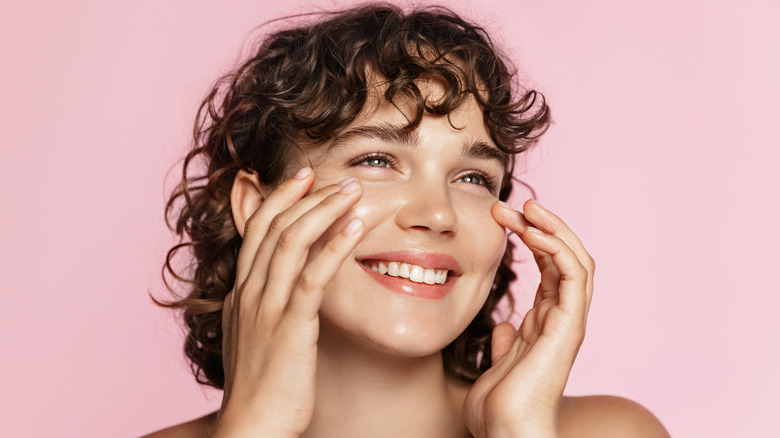 woman doing skincare, woman using moisturizer