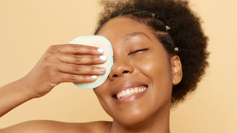 Woman removing eye makeup