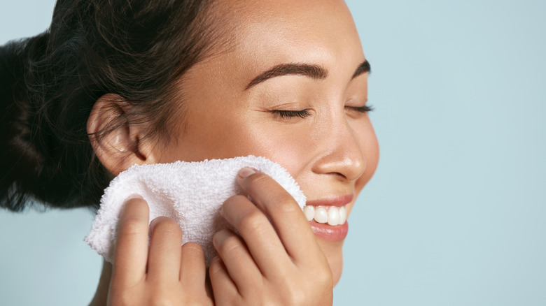 Woman removing her makeup with a cloth