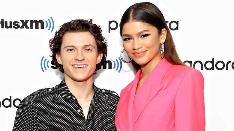 Tom Holland and Zendaya smiling at event