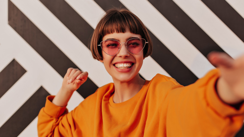 Woman smiling in orange outfit