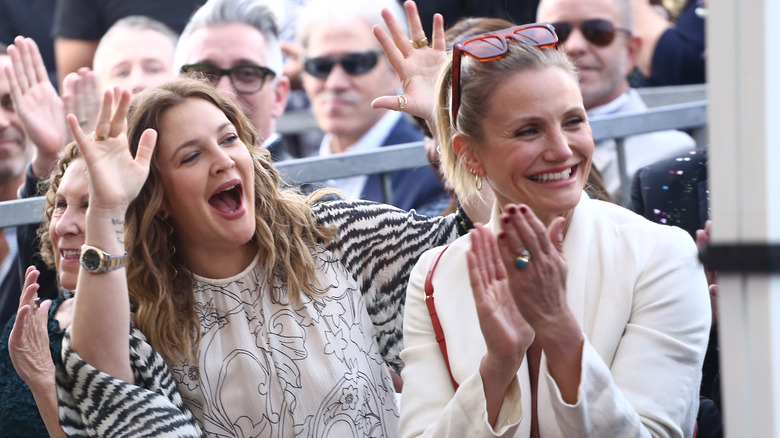 Drew Barrymore and Cameron Diaz cheering and smiling 