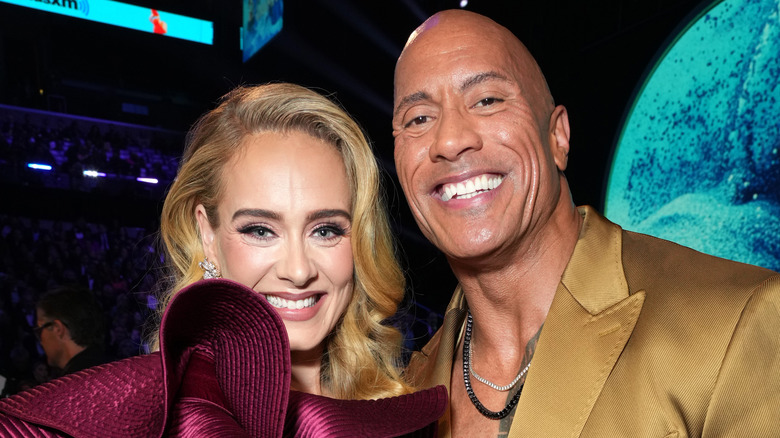 Adele and Dwayne Johnson smiling at Grammys