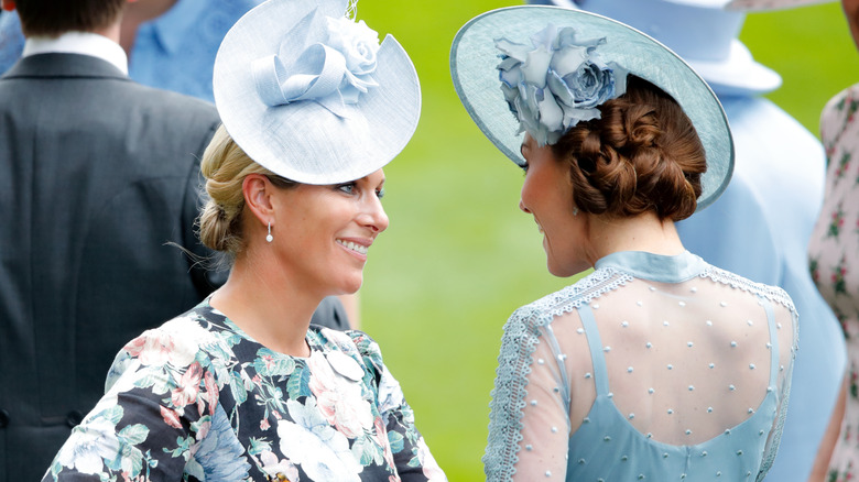 A smiling Zara Tindall and Princess Catherine engaging in conversation