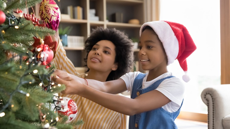 Mother and child decorating Christmas tree