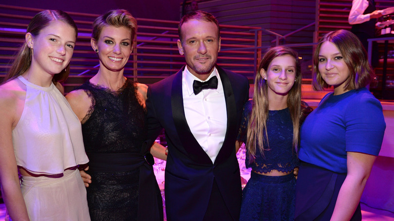 Faith Hill, Tim McGraw, and their daughters at an event