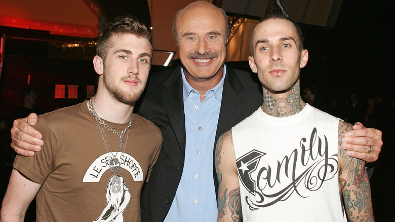 Phil McGraw arms around Jordan McGaw and Travis Barker