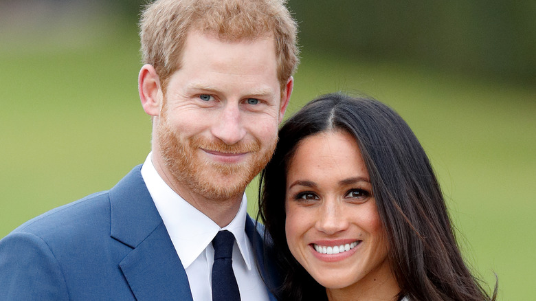 Prince Harry and Meghan Markle pose for the camera. 