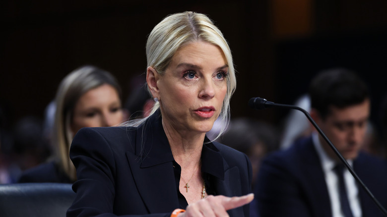 Pam Bondi pointing during a hearing while wearing a black suit