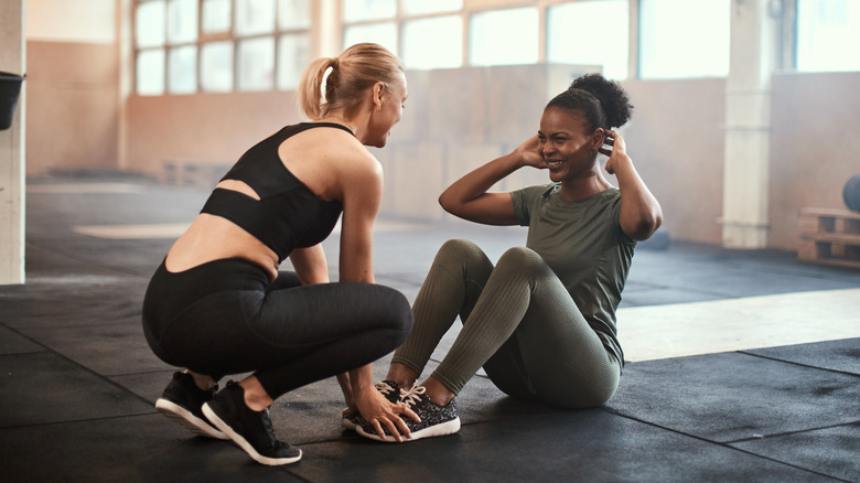 Two friends working out in a gym