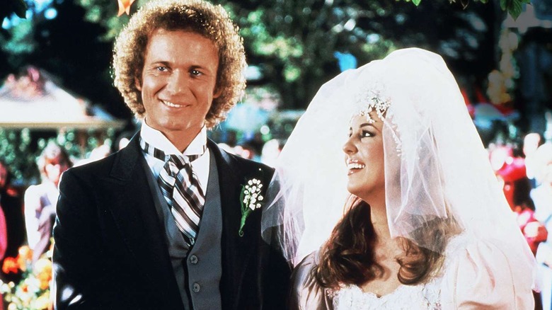Luke and Laura stand at the altar