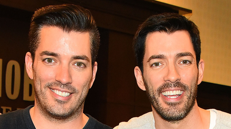 Drew and Jonathan Scott smiling at an event