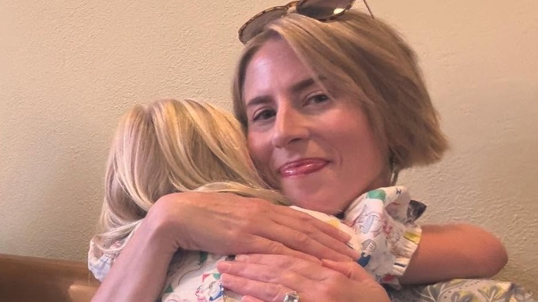 Erin Napier hugging one of her children