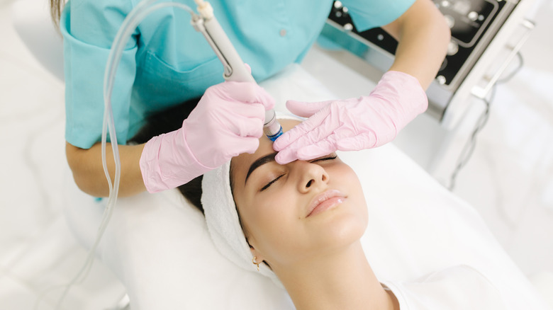 Woman having facial treatment