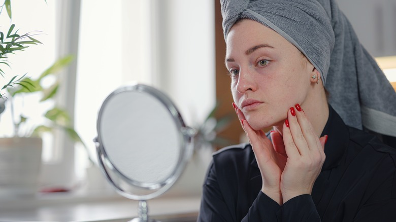 woman examining her jaw