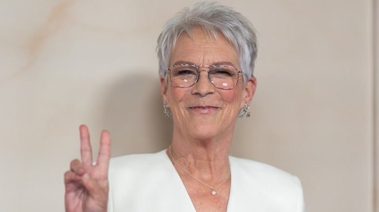 Jamie Lee Curtis holding up a peace sign