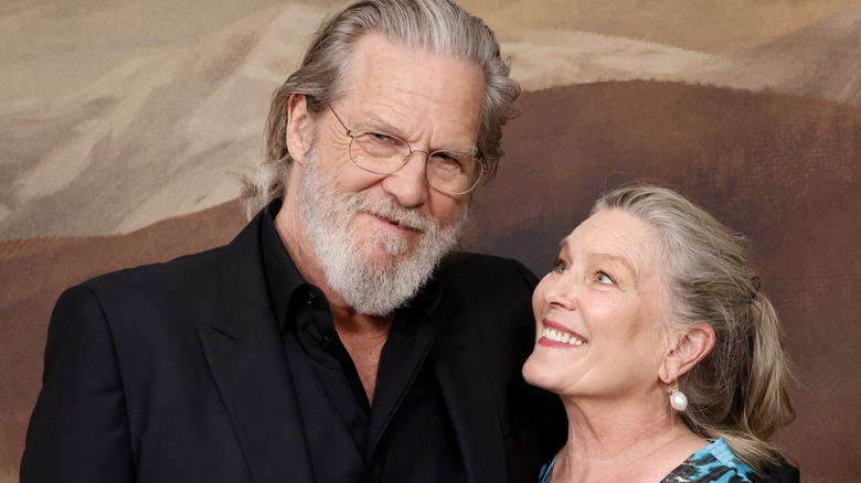 Jeff Bridges posing with his wife, Susan, gazing up at him with a wide smile