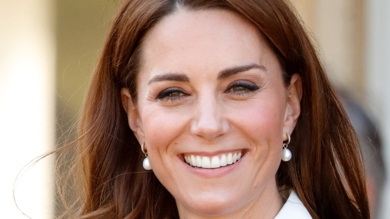 Kate Middleton, Princess of Wales, big smile with pearl earrings 