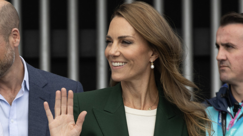 A smiling Princess Catherine waving at the crowd