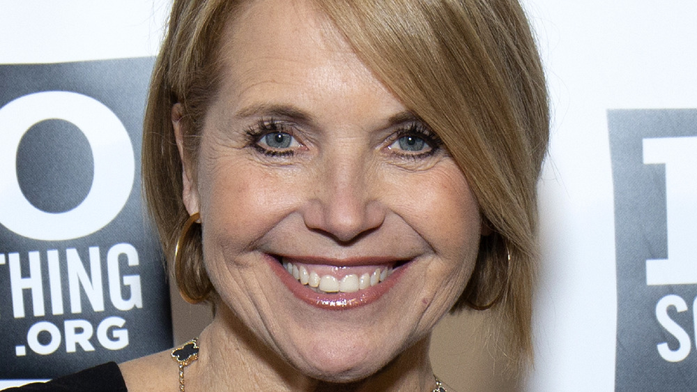 Katie Couric smiling on the red carpet