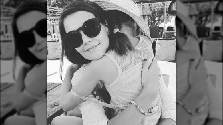 Katie Holmes embracing her daughter Suri Cruise