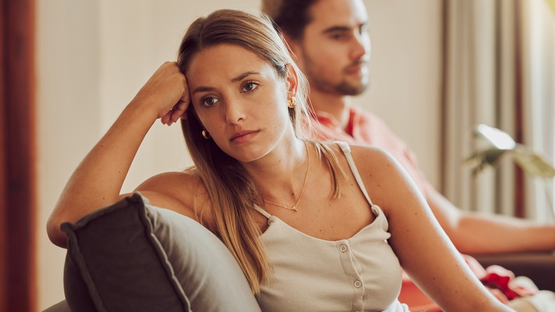 Unhappy couple sitting on the couch