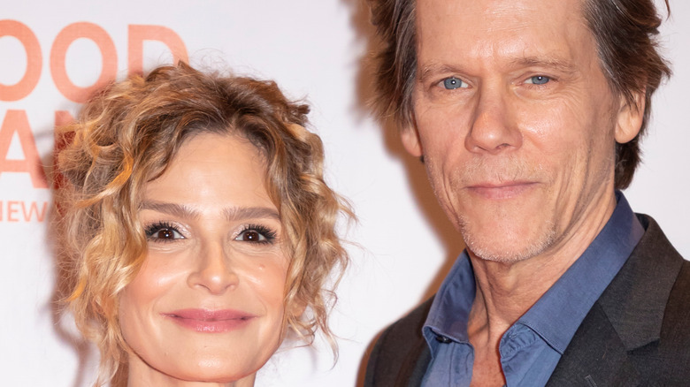 Kevin Bacon and Kyra Sedgwick smile at an event