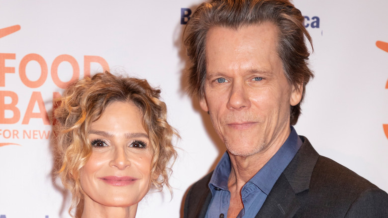 Kevin Bacon and Kyra Sedgwick smile at an event