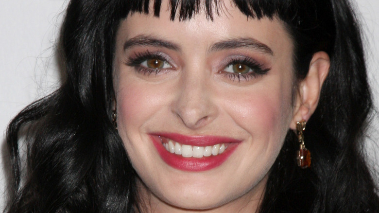 Krysten Ritter smiles at an event